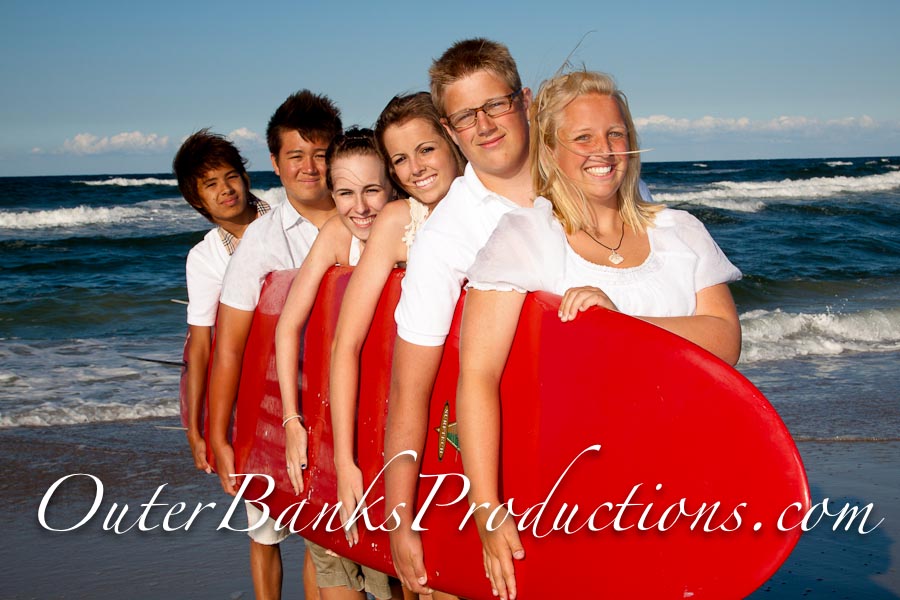 Bright red surfboard prop for family portraits.